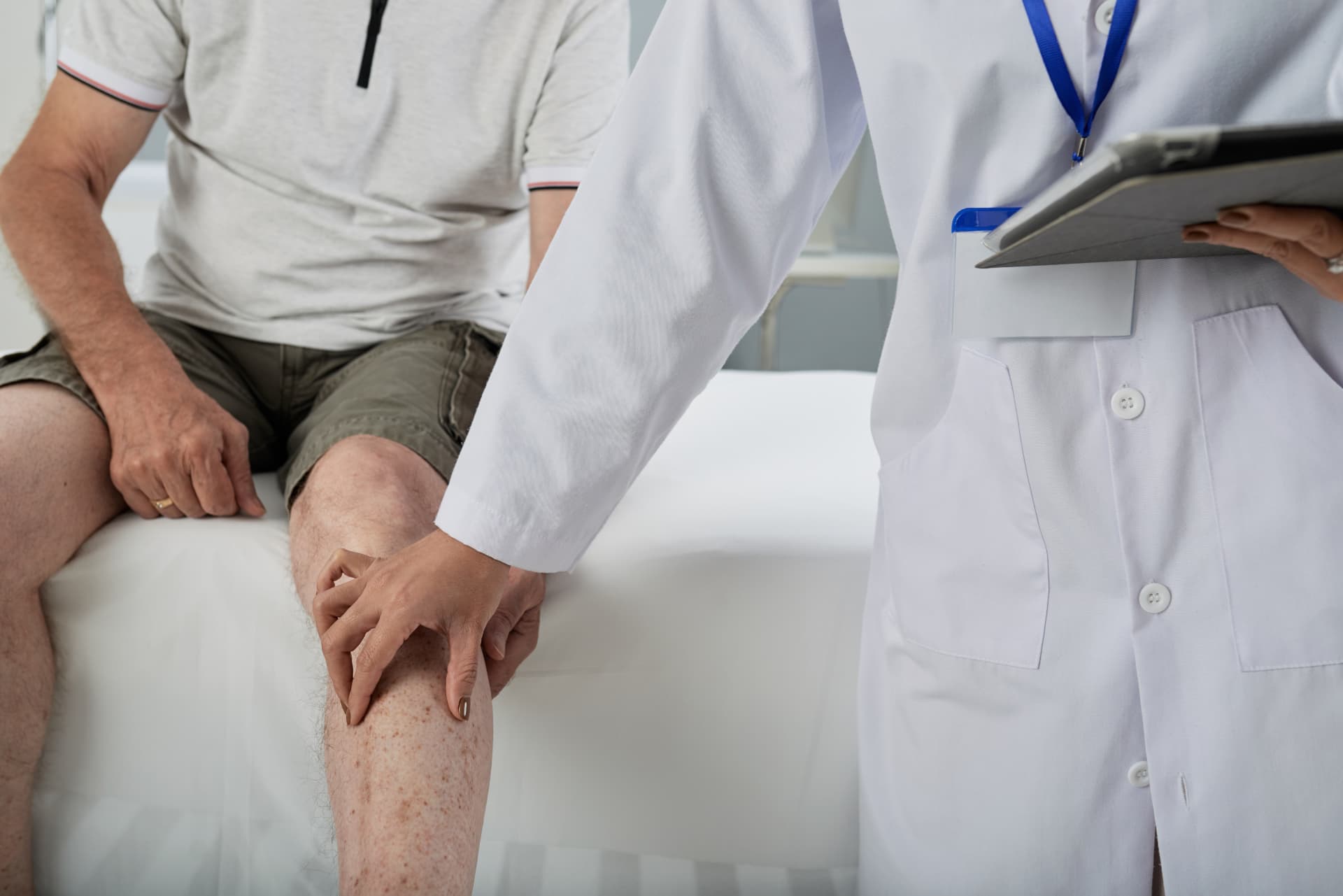 Physician examining a patient's joint mobility during a chondrogenic MSC consultation